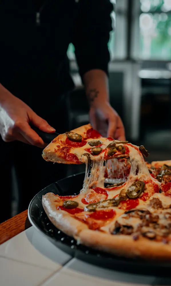 a person holding a pizza