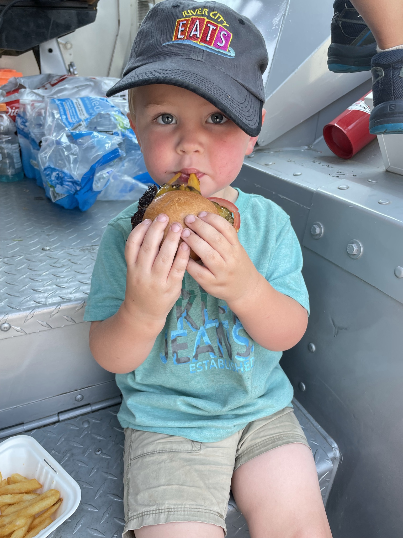 a young boy eating a hot dog