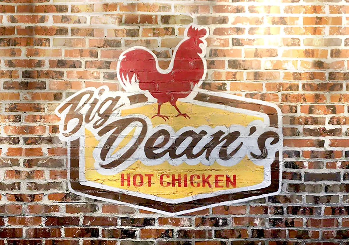 a sign in front of a brick building