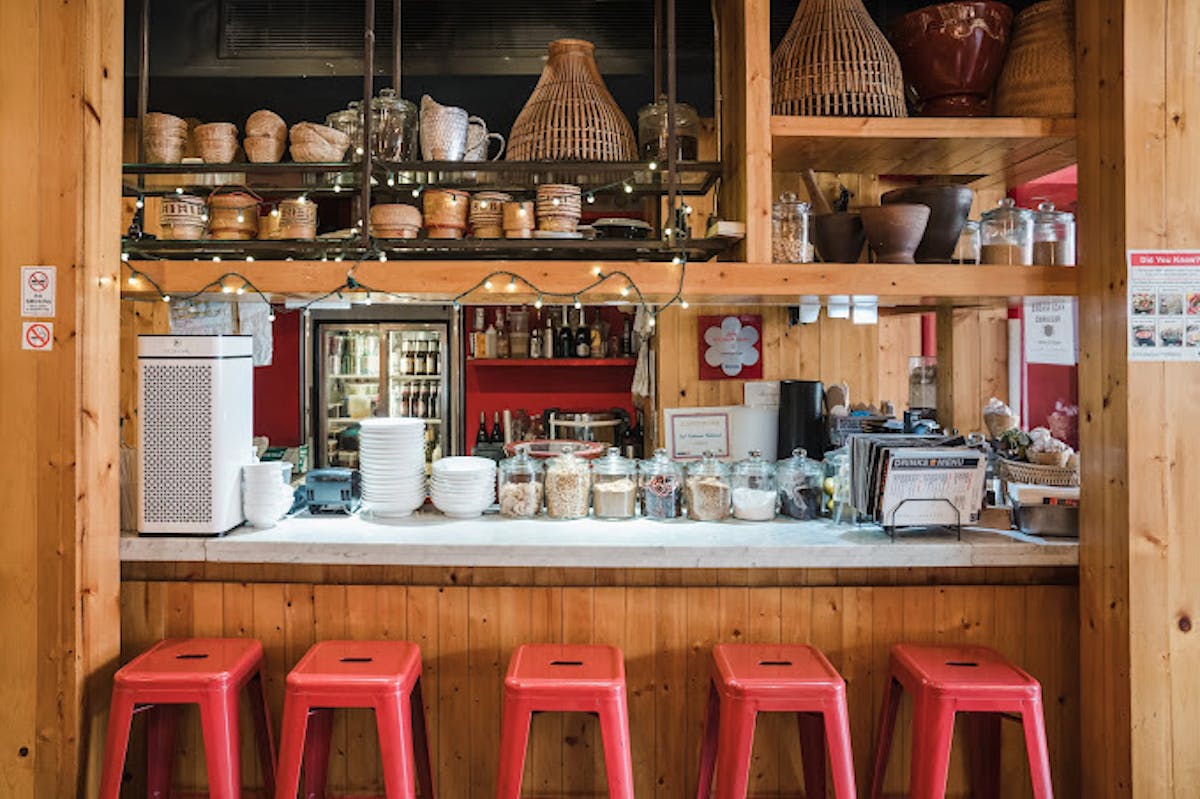 a group of pink flowers on a kitchen counter