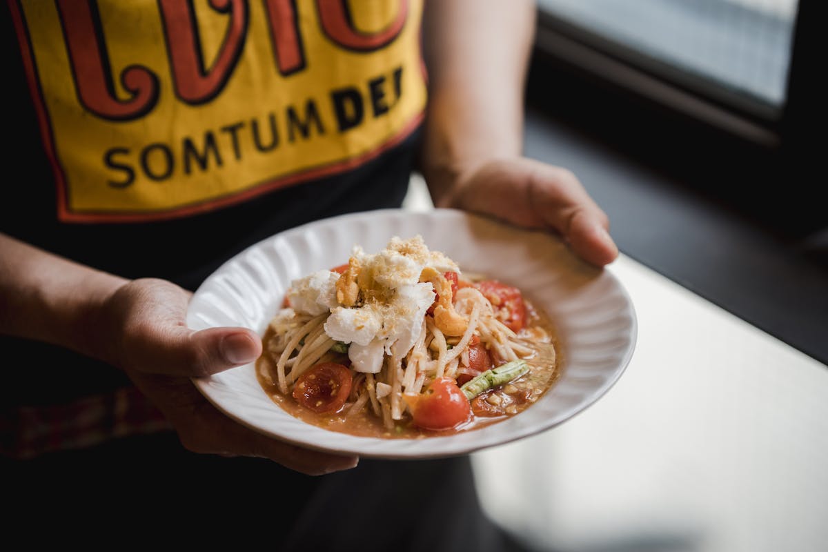 a person sitting at a table with a plate of food