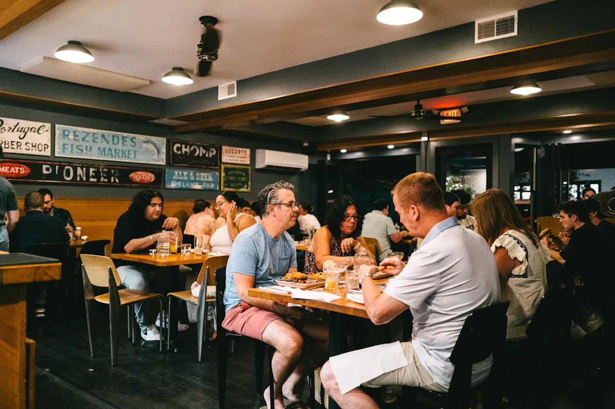 a group of people sitting at a table in a restaurant