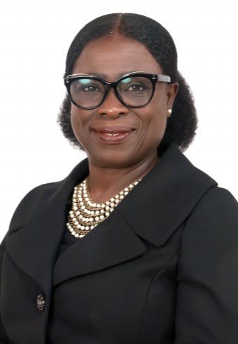 a person wearing glasses and smiling at the camera