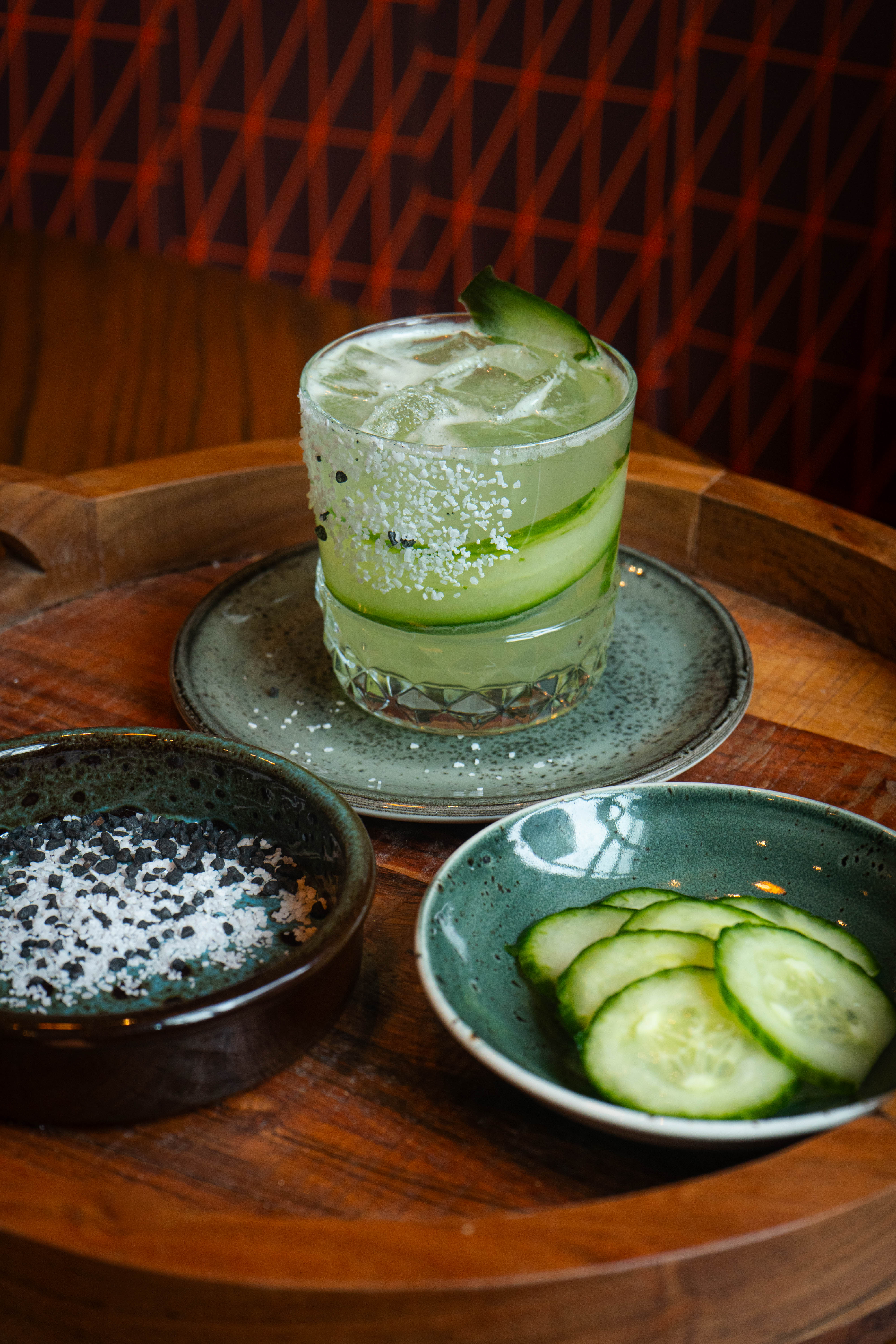 a glass of cucumber and salt on a table