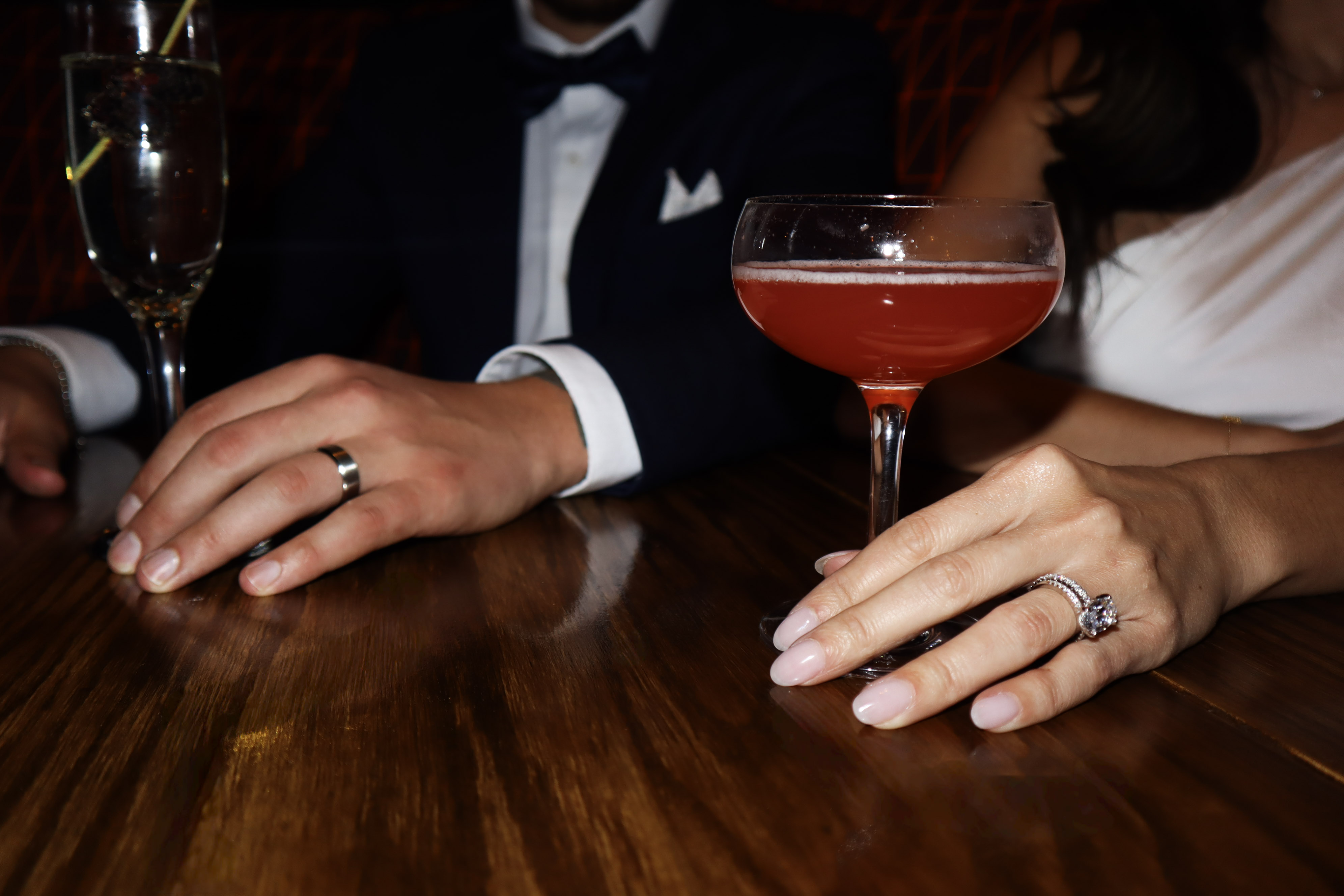 a hand holding a glass of liquid