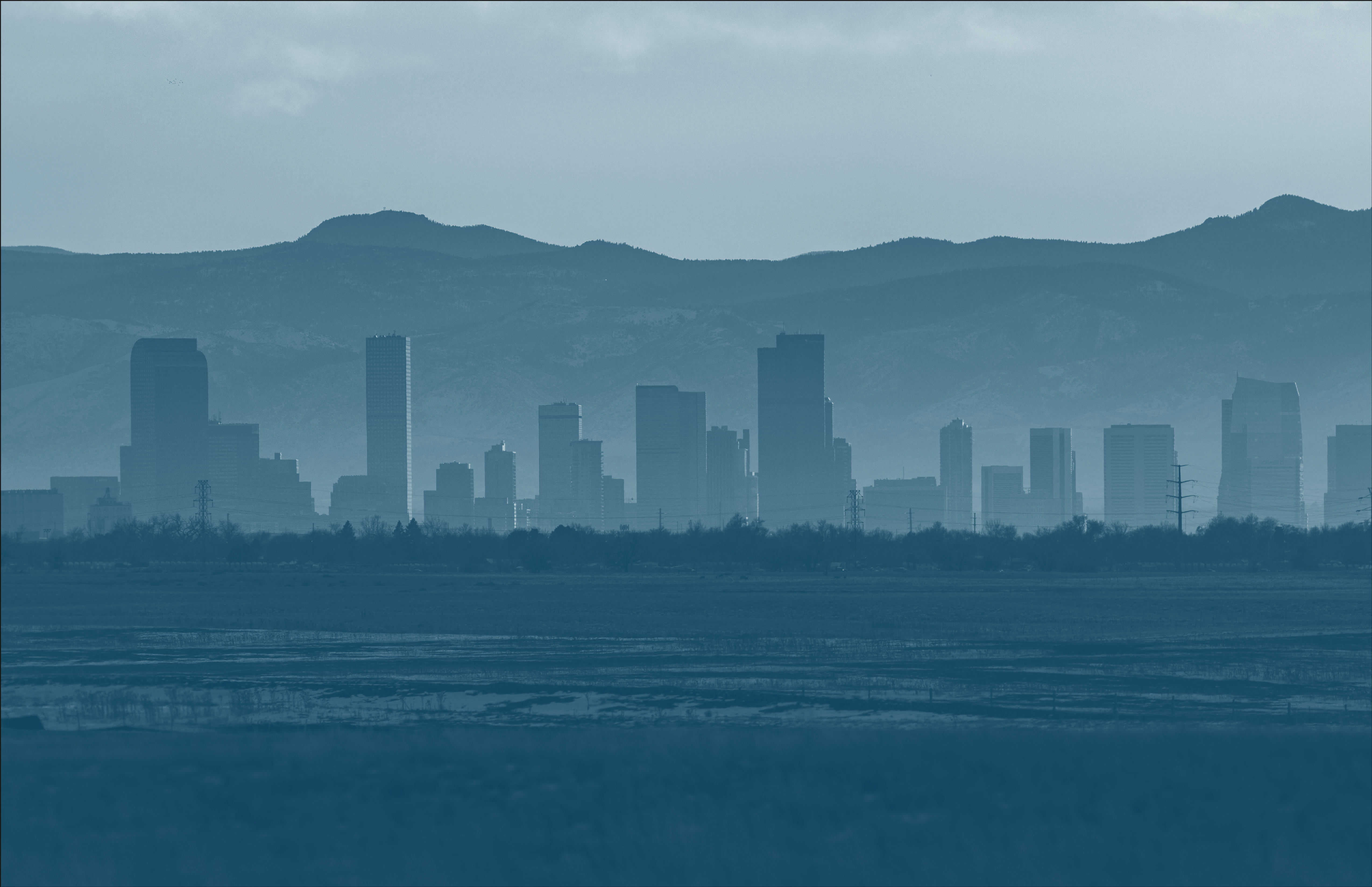 a large body of water with a city in the background