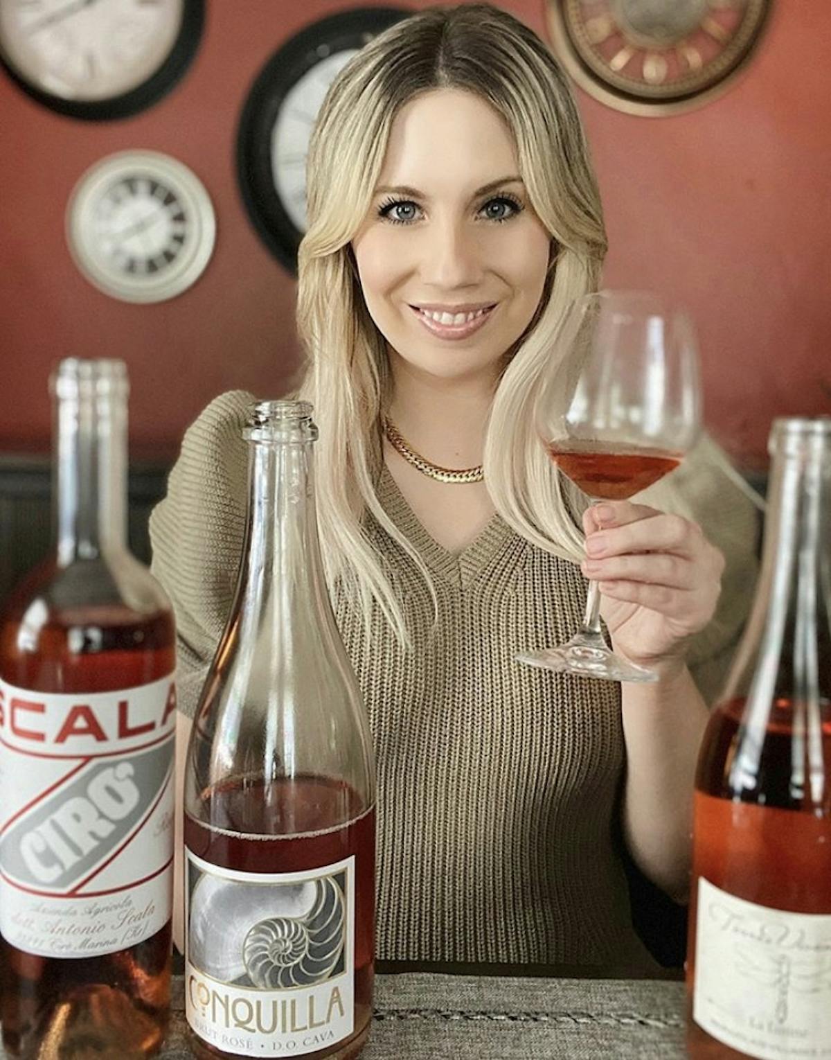 a woman holding a bottle of wine