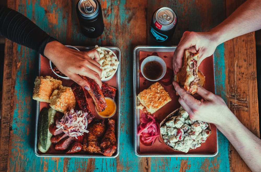 a person cutting a piece of pizza