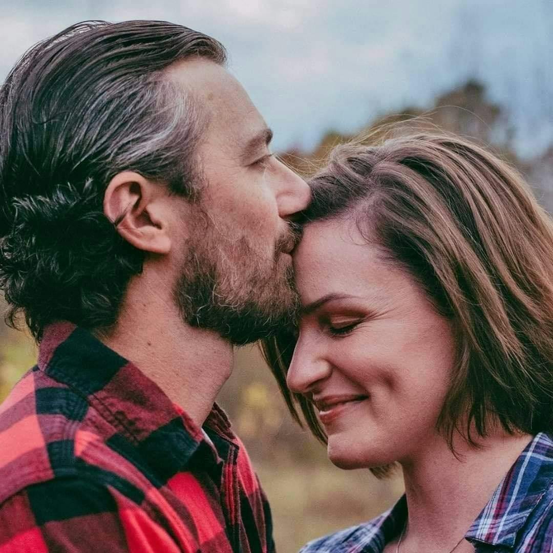 a man and a woman looking at the camera