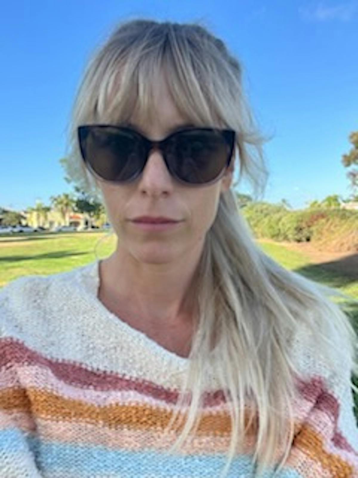 a person wearing sunglasses posing for the camera