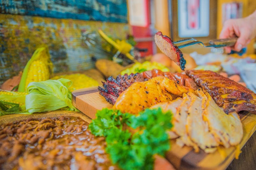 a slice of pizza on a cutting board with a cake