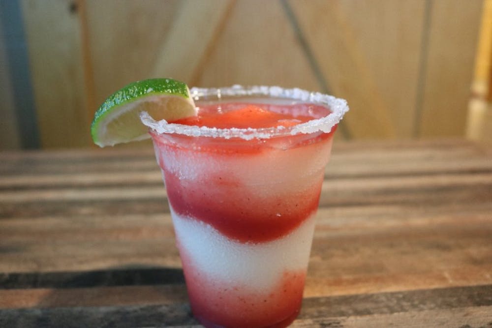 a cup of coffee sitting on top of a wooden table