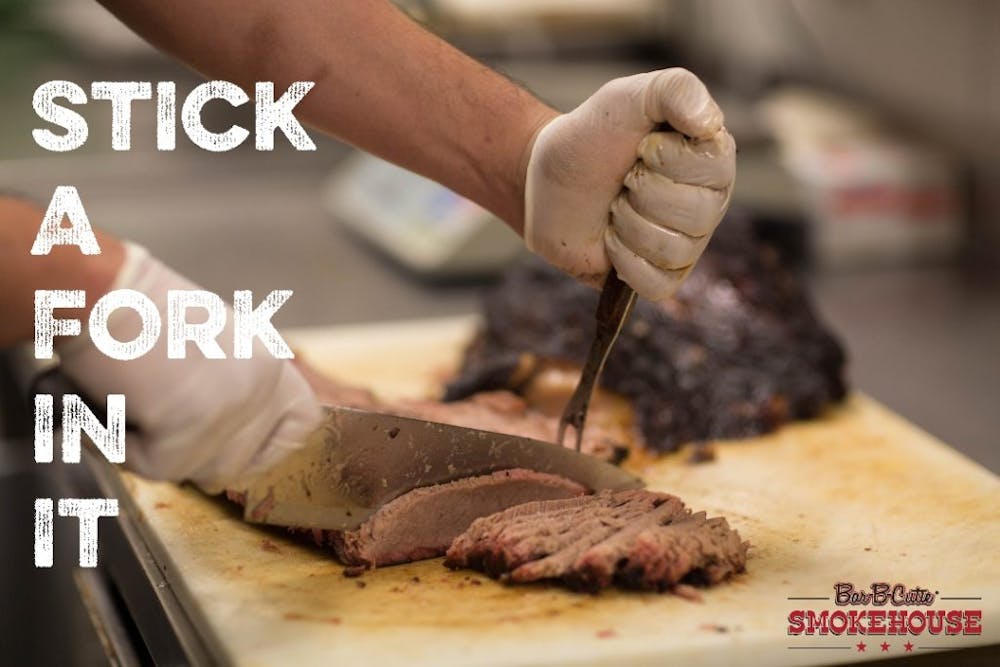 a close up of a person cutting a piece of cake