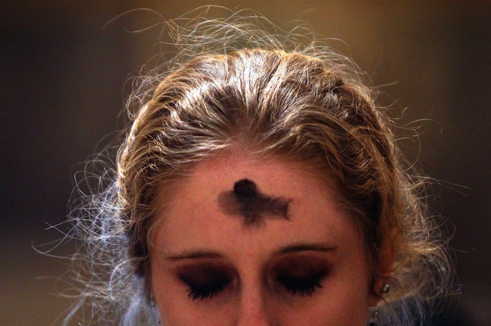 a close up of a person with pink hair looking at the camera