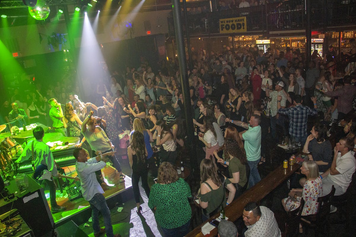 a group of people performing on stage in front of a crowd