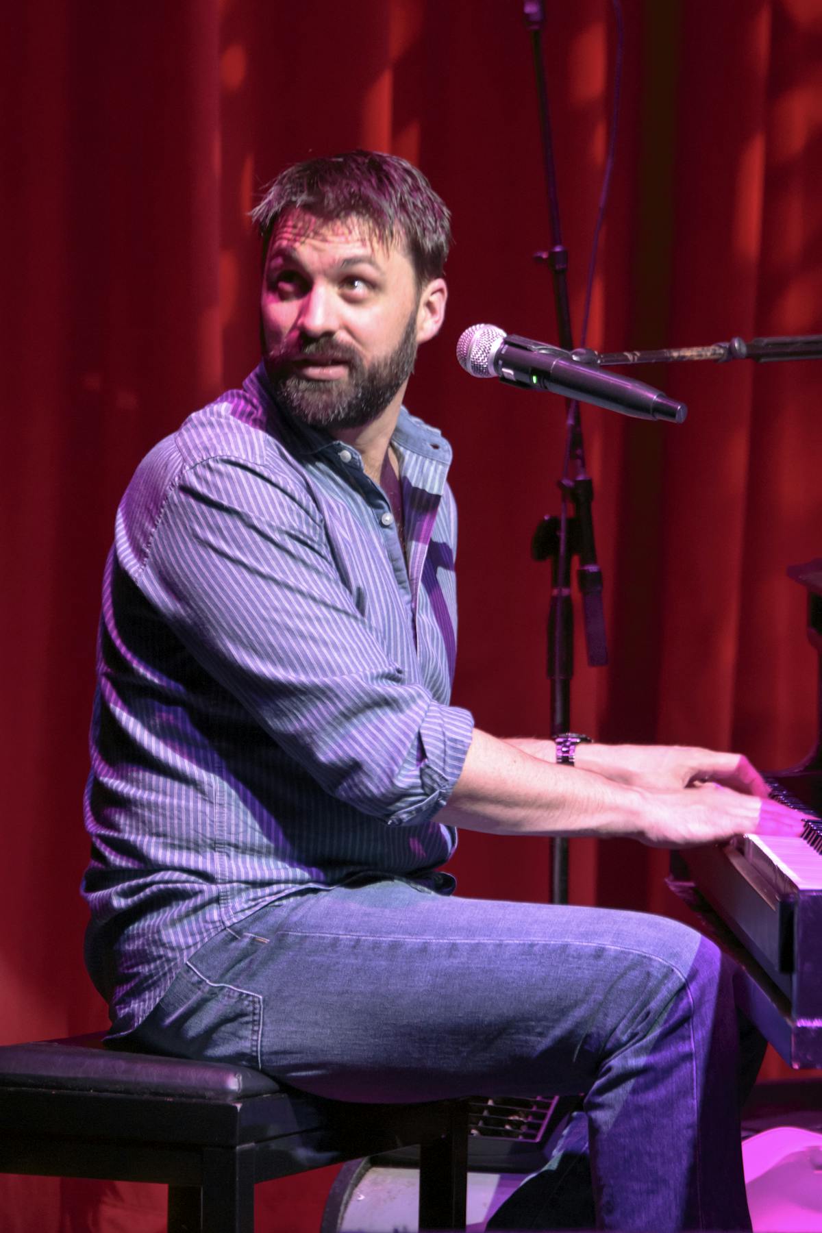 a man sitting in front of a piano