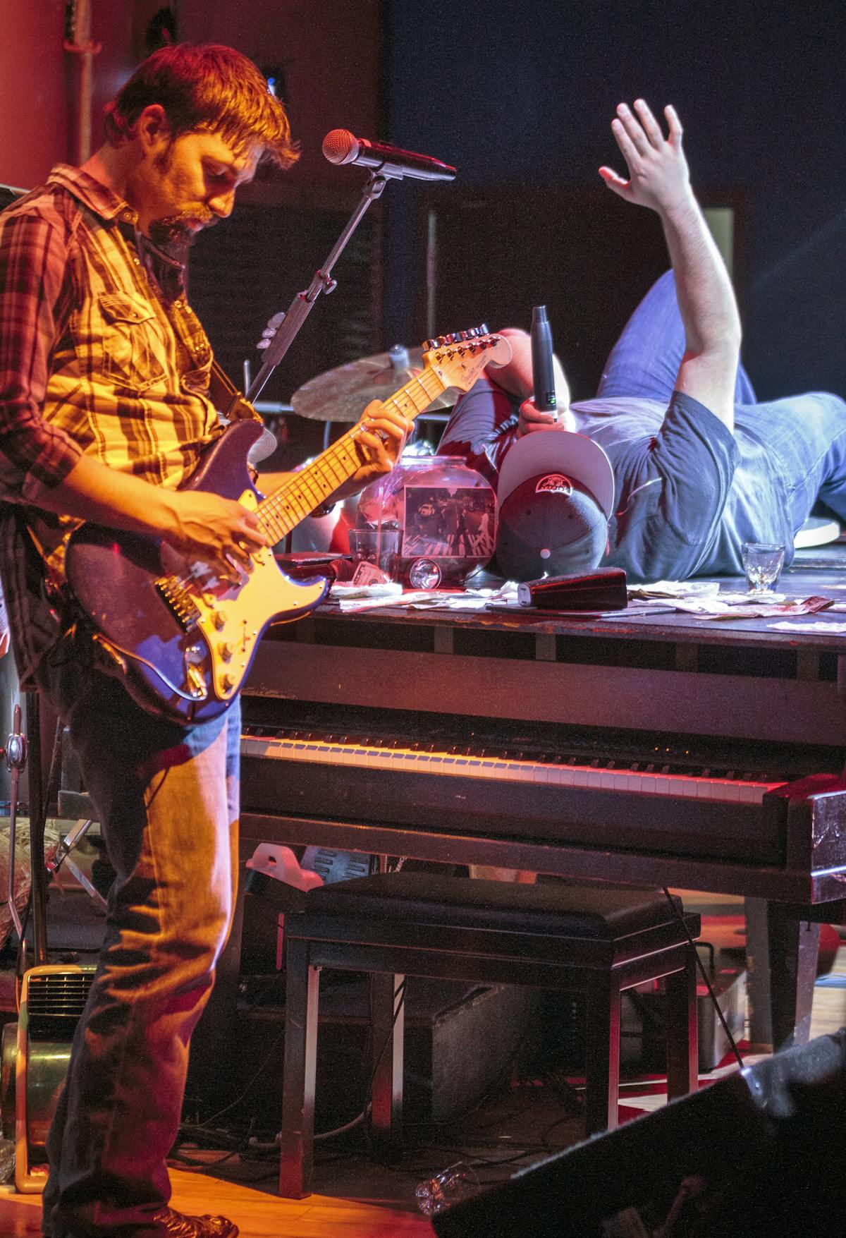 a person standing on a stage playing instruments