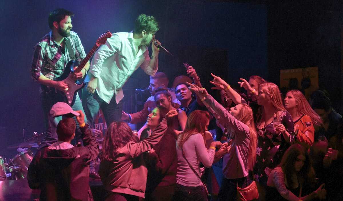 a group of people on a stage in front of a crowd