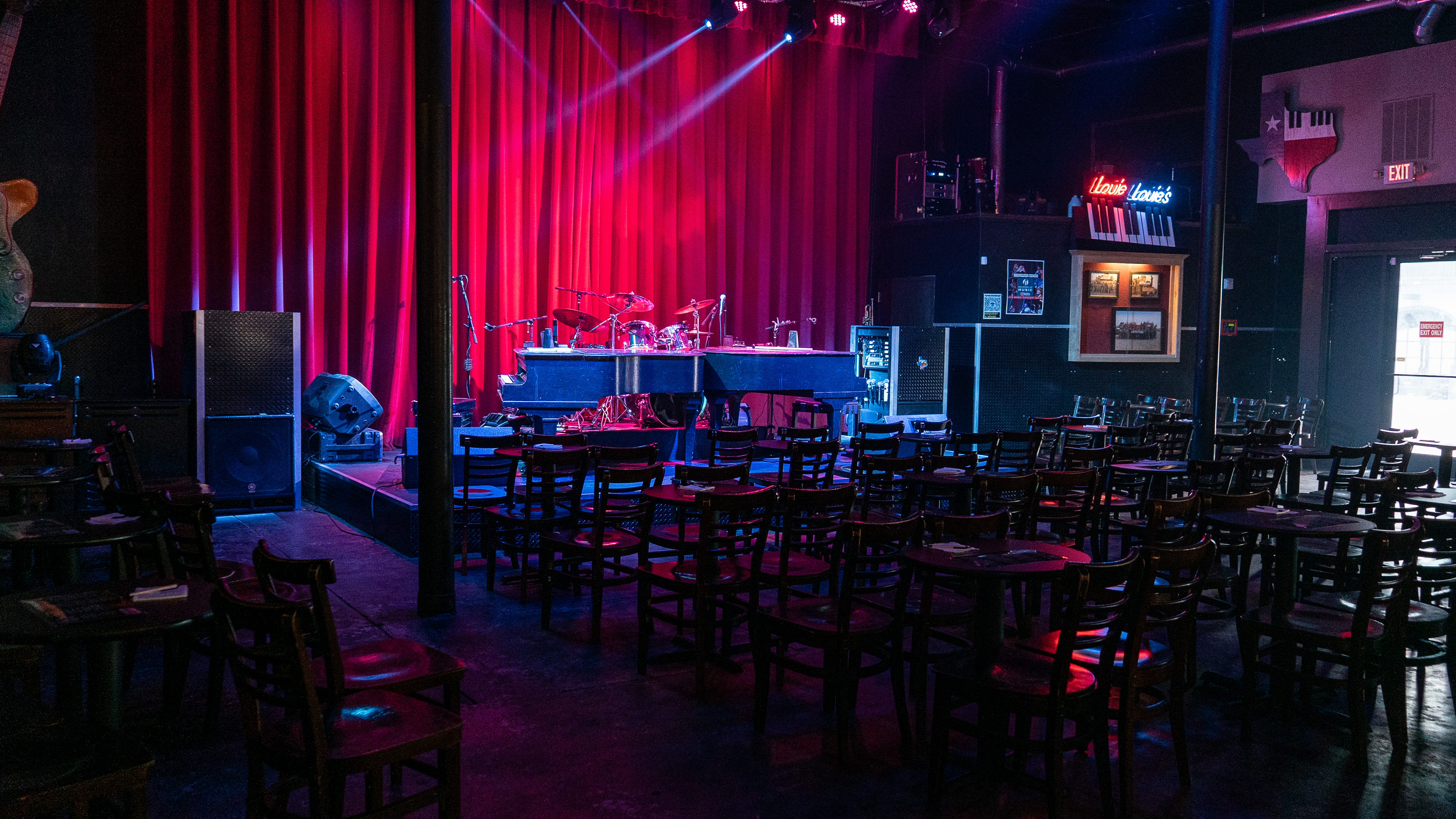 a group of people on a stage in front of a curtain