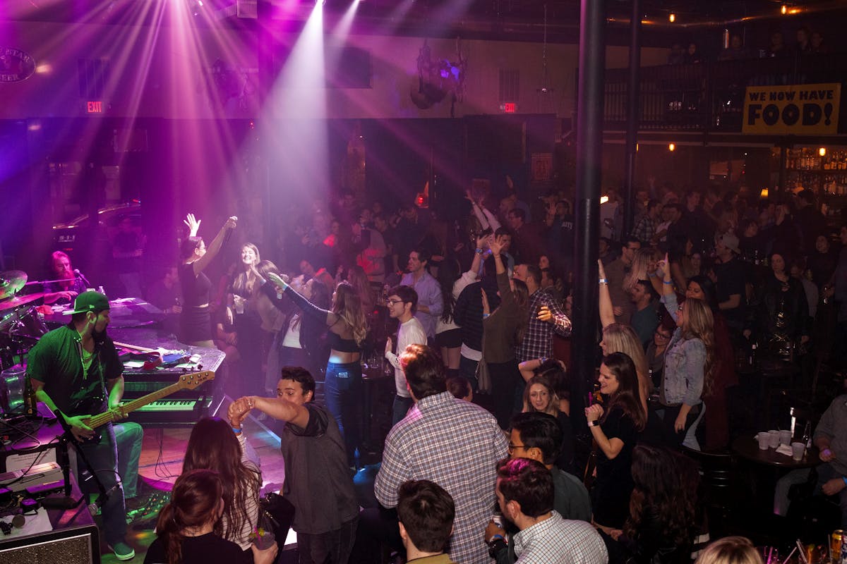 a group of people on a stage in front of a crowd