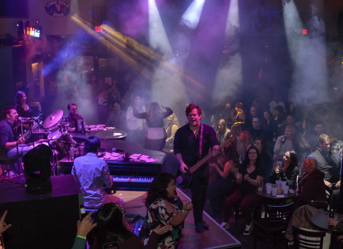 a group of people on a stage in front of a crowd