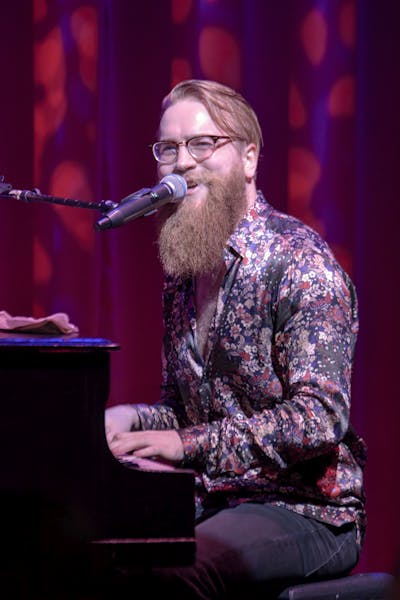 a man sitting on a stage