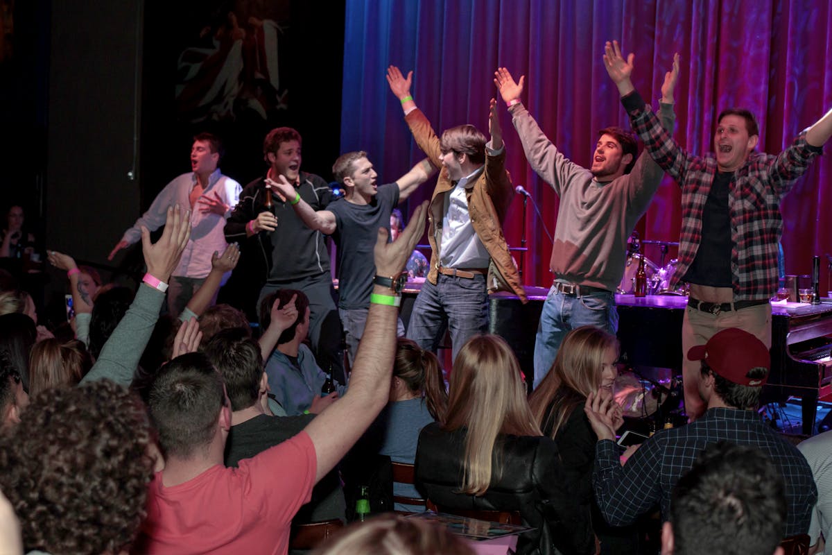 a group of people on a stage in front of a crowd