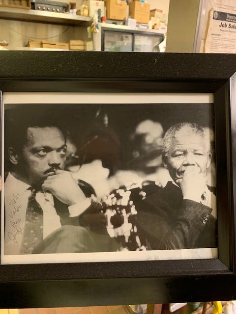 Nelson Mandela et al. in front of a window