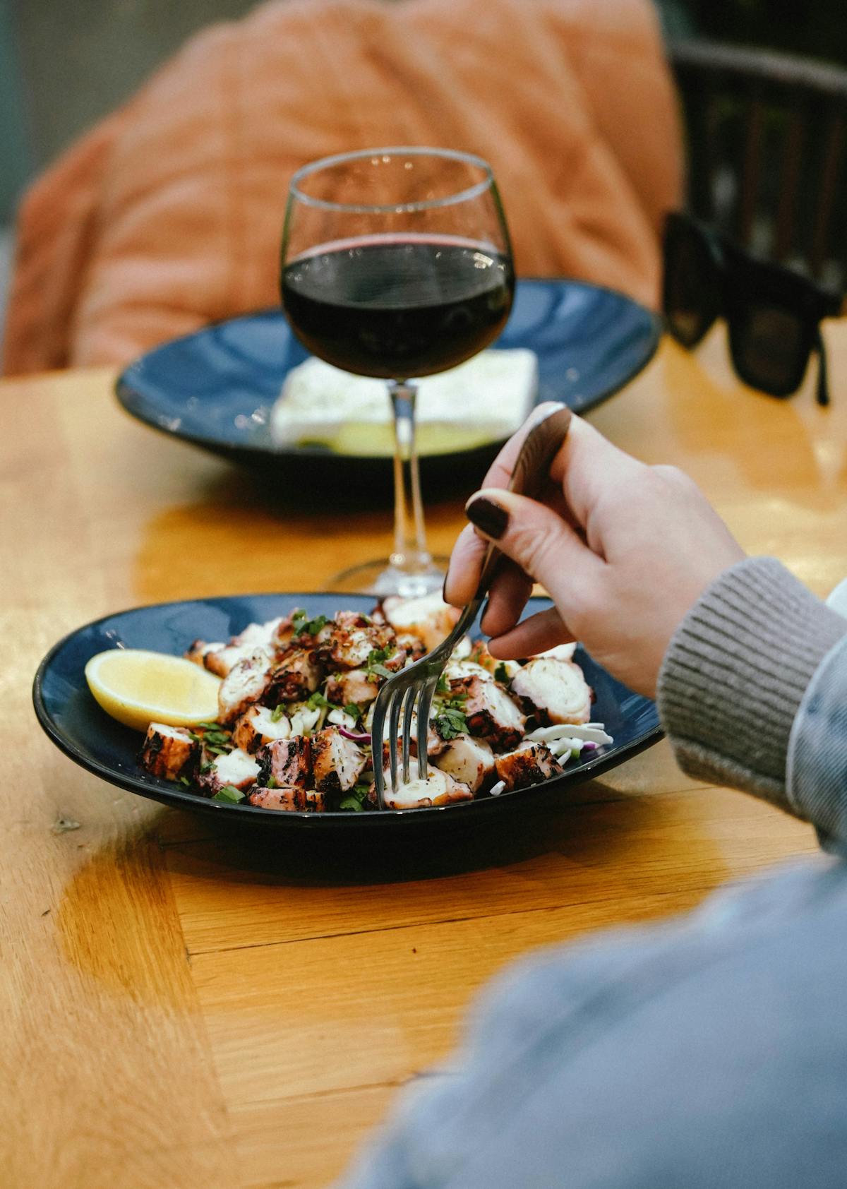 a person sitting at a table with a plate of food