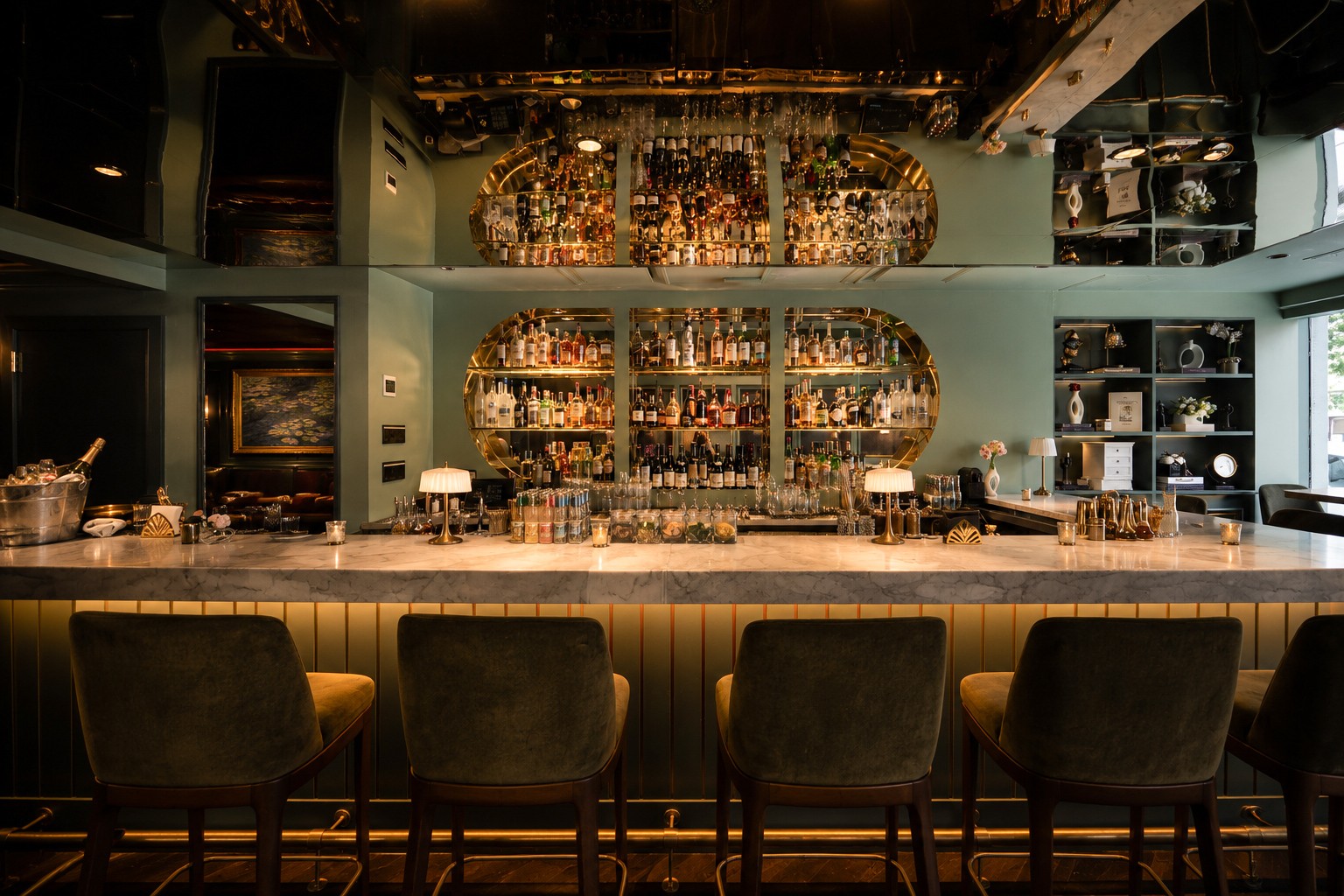 The Bar at Maison Madison with elegant seating, warm lighting, and a polished bar area