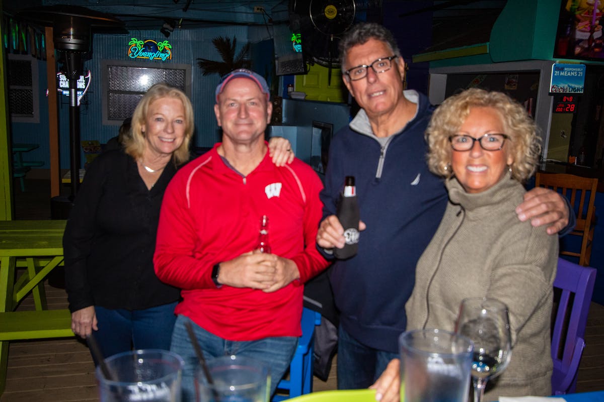 a group of people holding wine glasses