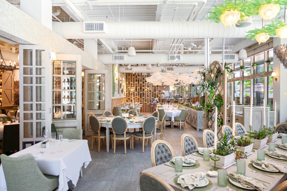 a room filled with furniture and vase of flowers on a table