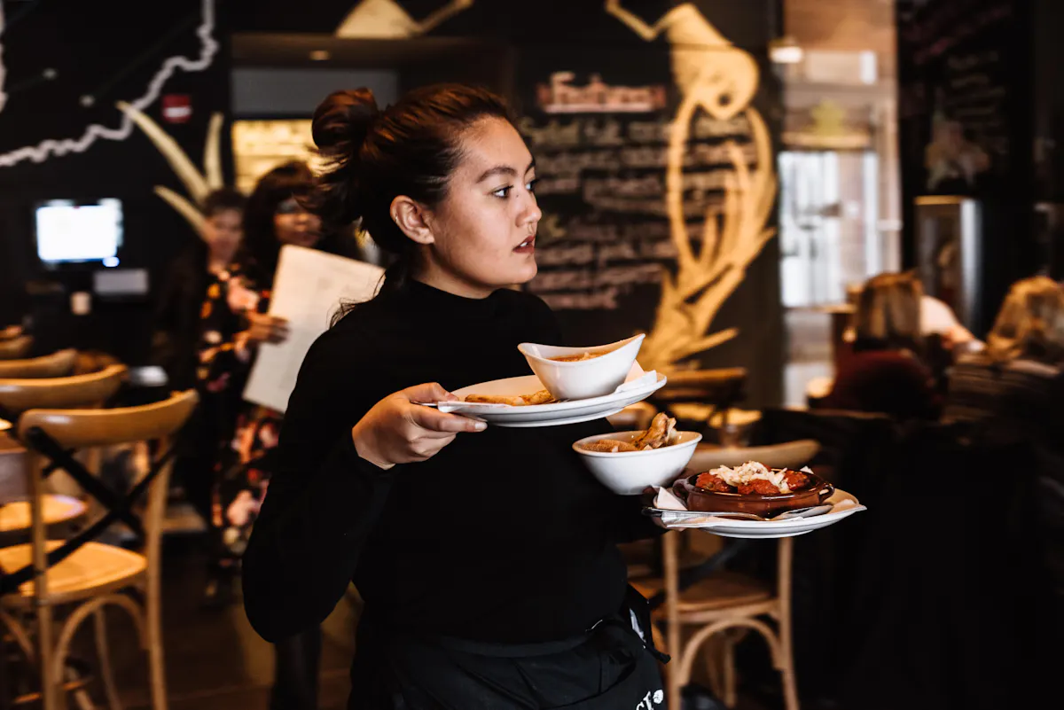 a person sitting at a table eating a meal at a restaurant