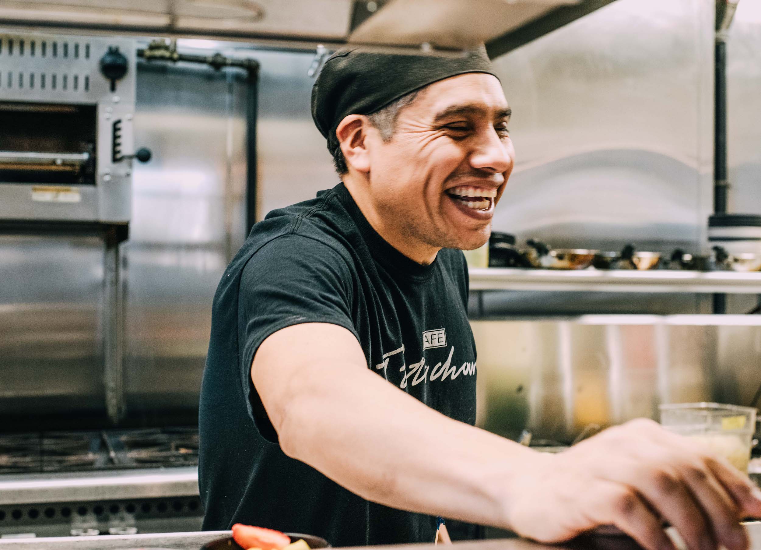 a man cooking in a kitchen preparing food
