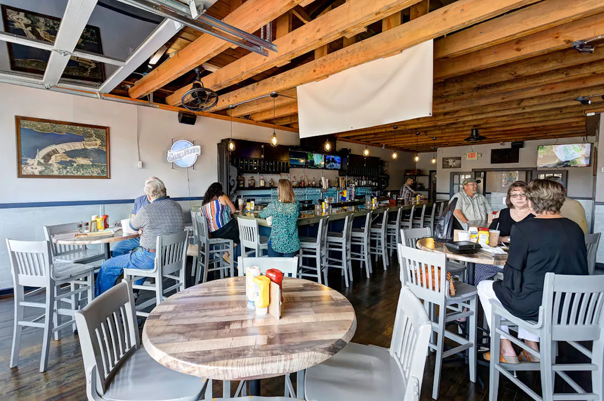 a person sitting at a table in a restaurant
