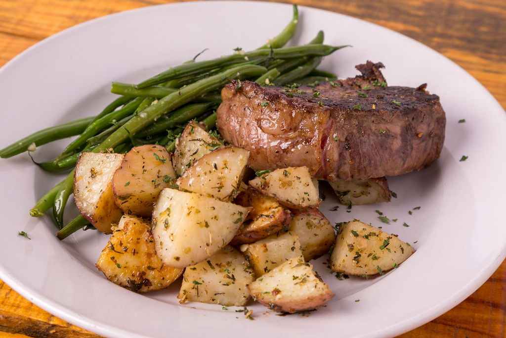 a plate of food with meat and vegetables