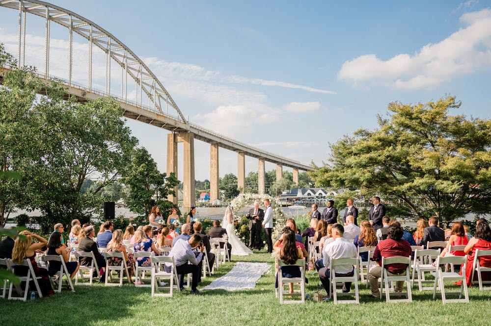 a group of people standing in front of a fence