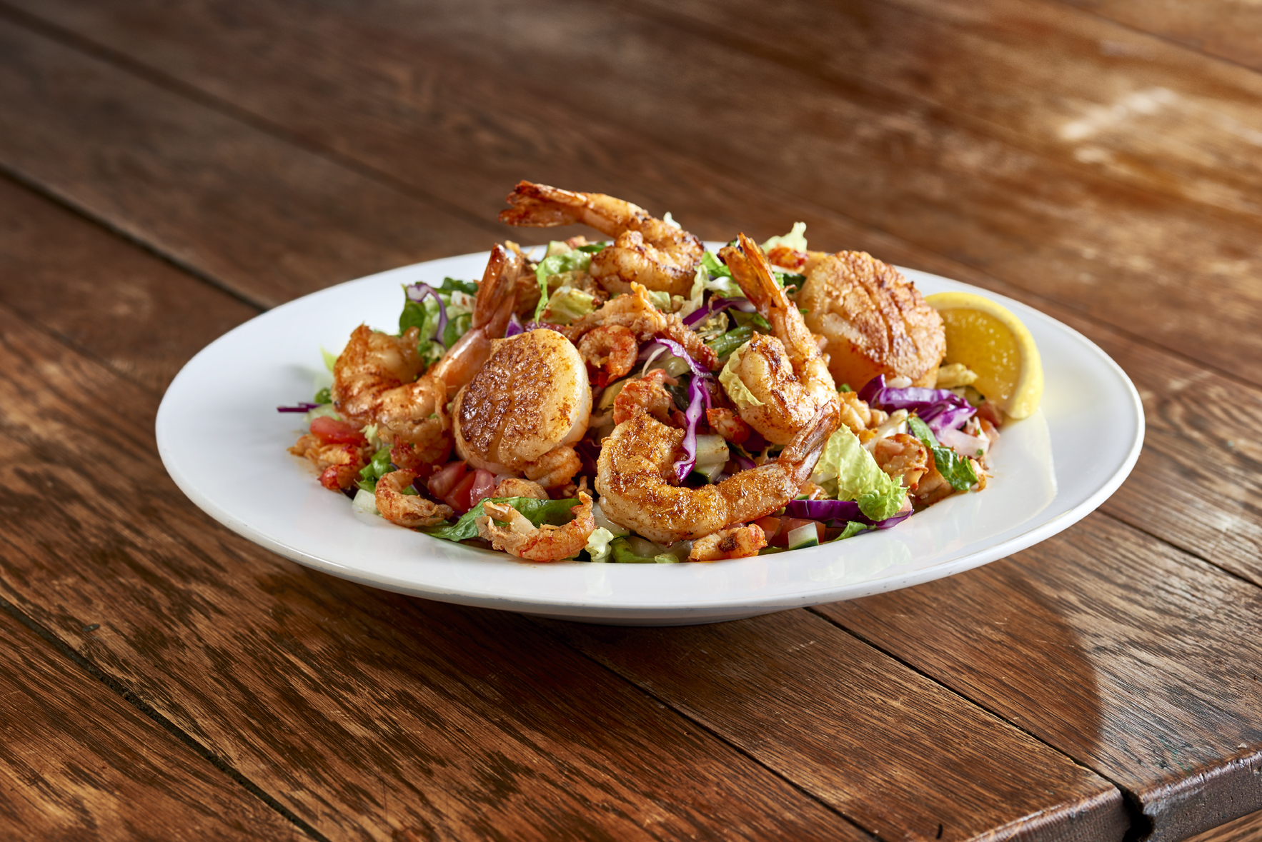 a plate of food sitting on top of a wooden table