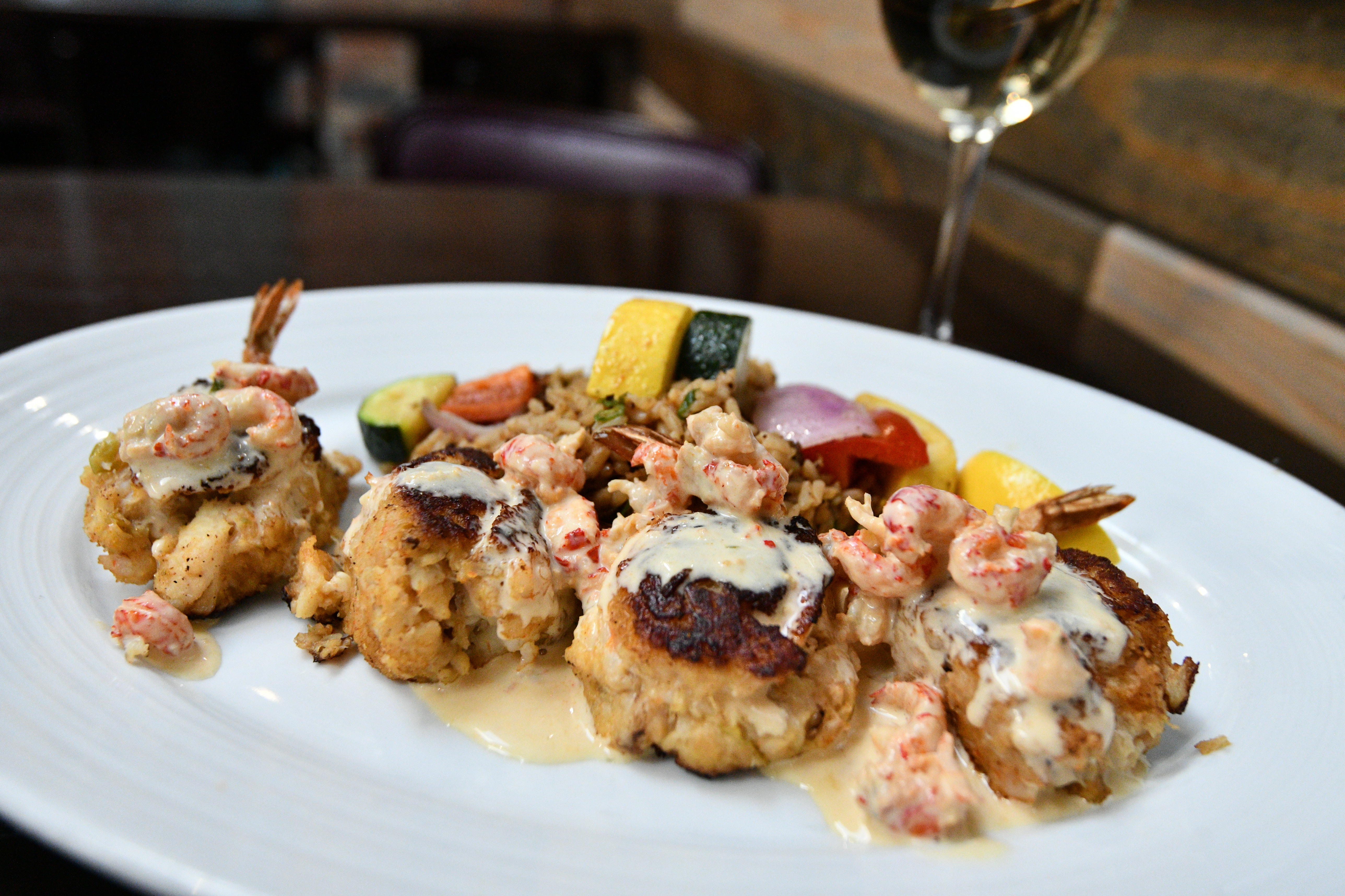 a plate of food and a glass of wine
