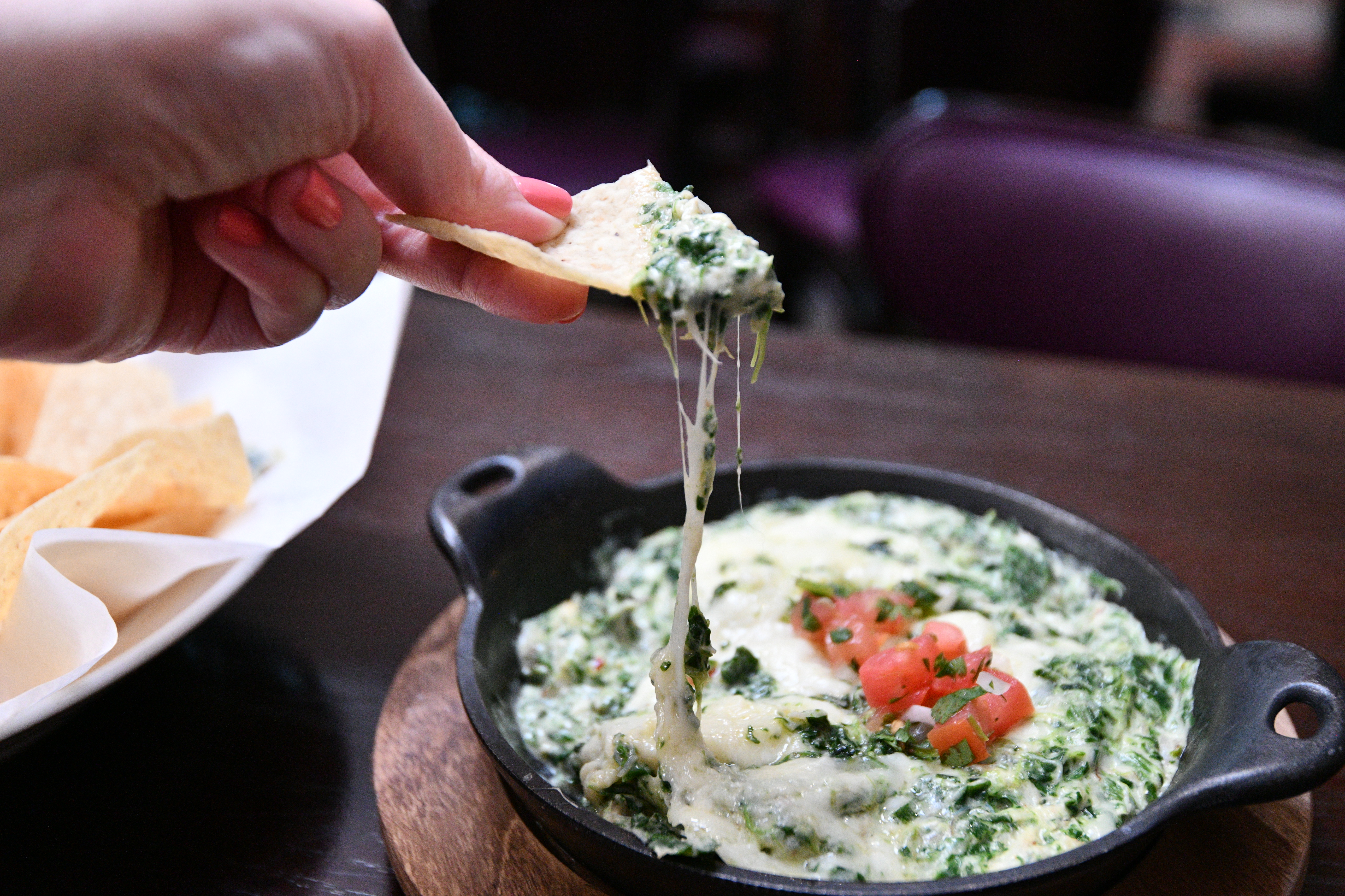 a close up of a person holding a plate of food on a table