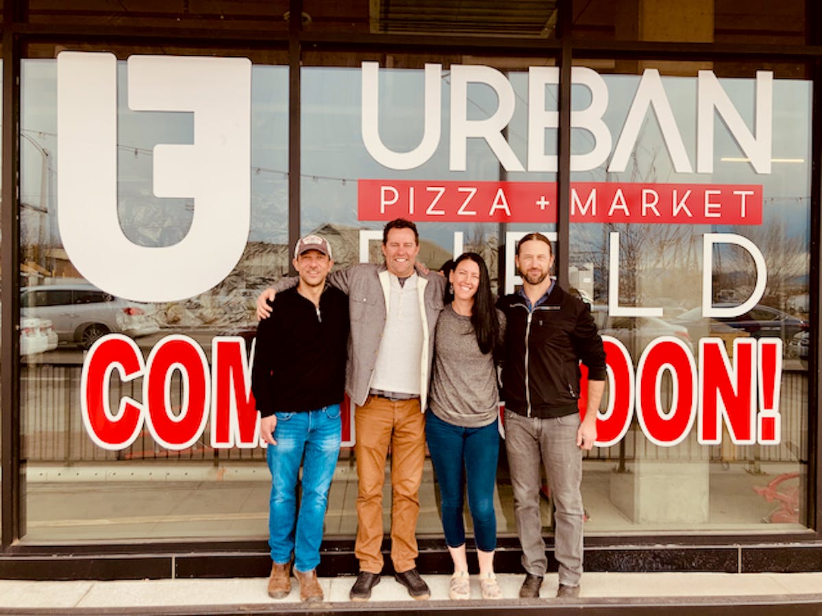 a group of people standing in front of a sign