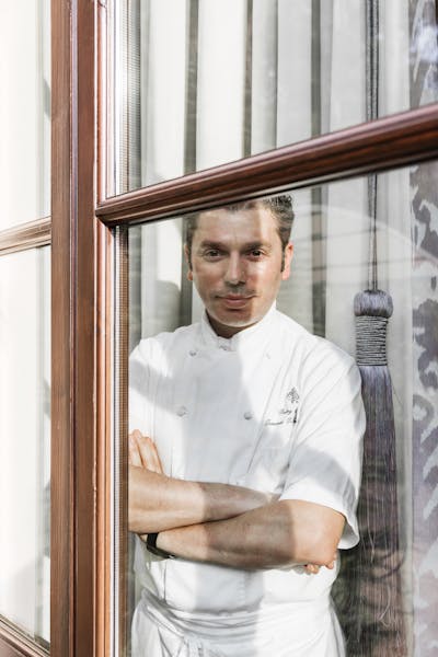 a man standing in front of a window