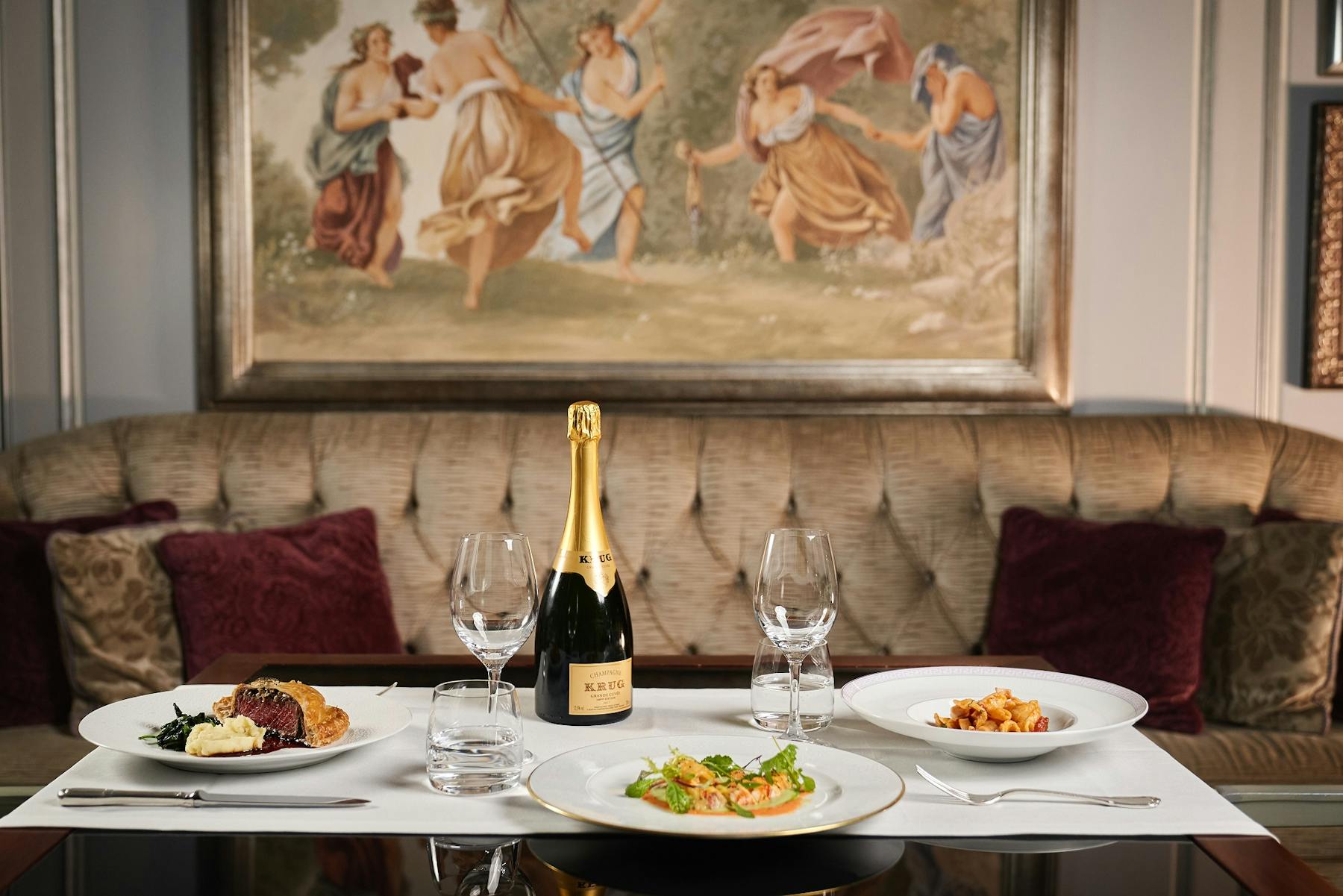 a plate of food and a glass of wine