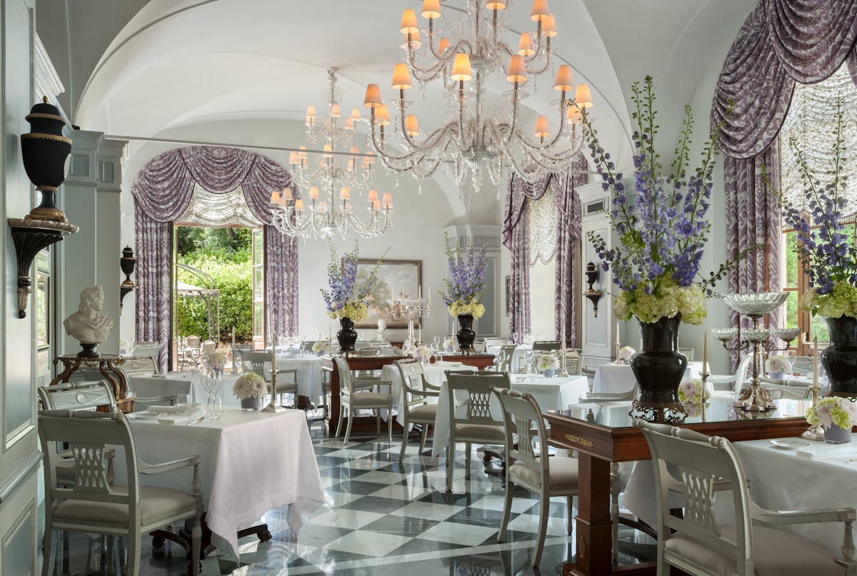 a room filled with furniture and vase of flowers on a table