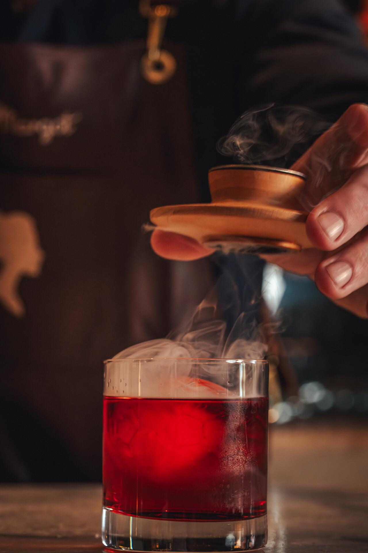 a person pouring a liquid into a glass