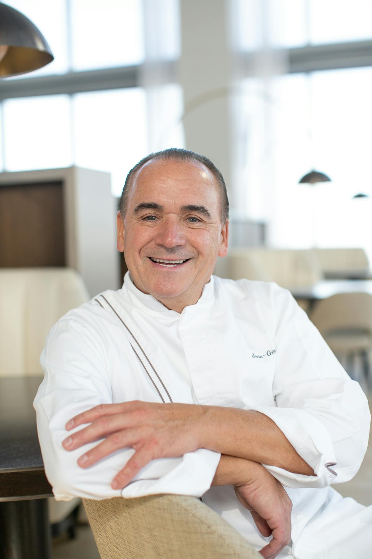 Jean-Georges Vongerichten sitting on a table
