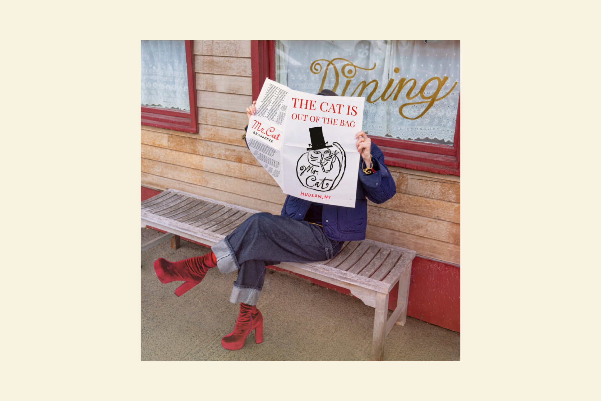 a person sitting on a bench holding a newspaper