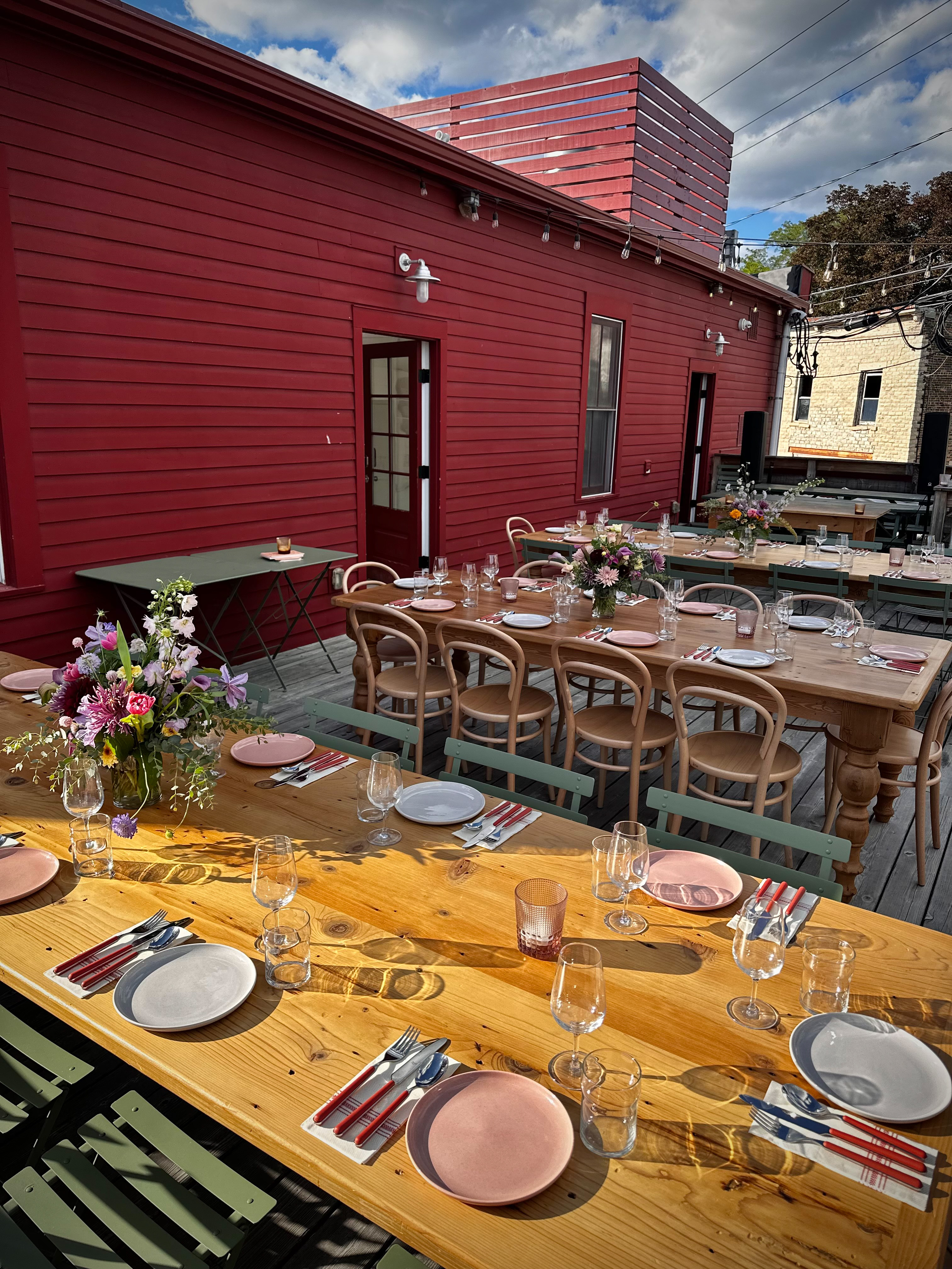 a group of people sitting at a table in front of a building