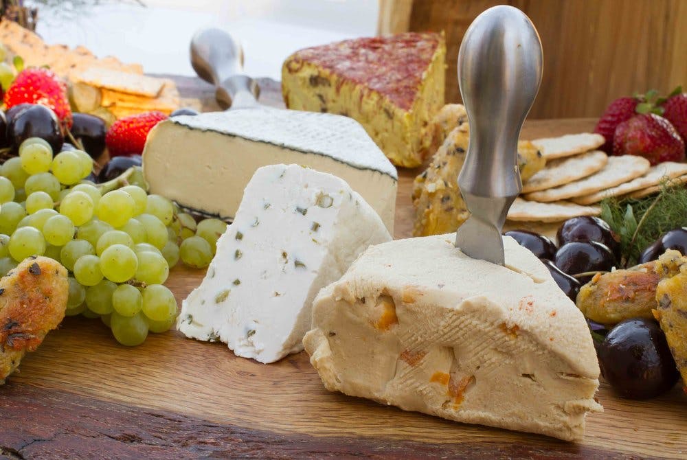 An array of different cheeses and grapes