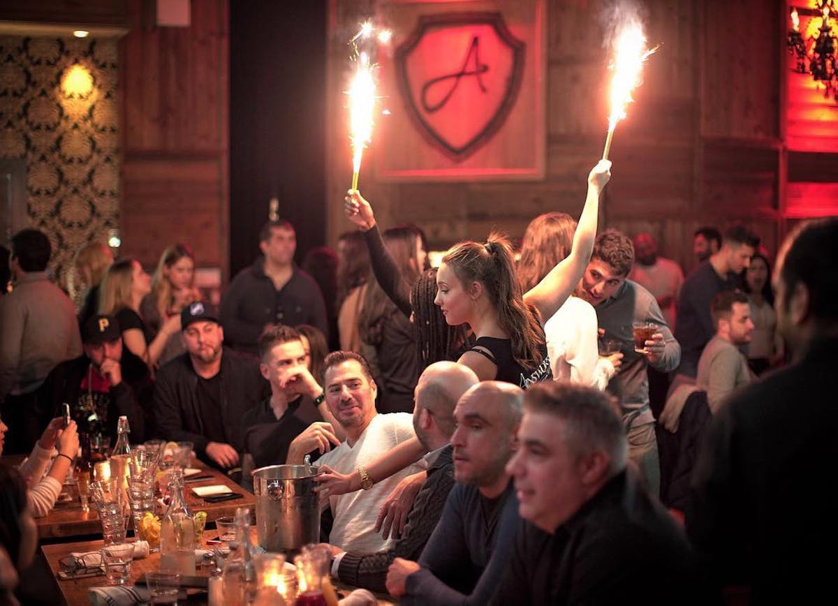 a group of people sitting at a table in front of a crowd